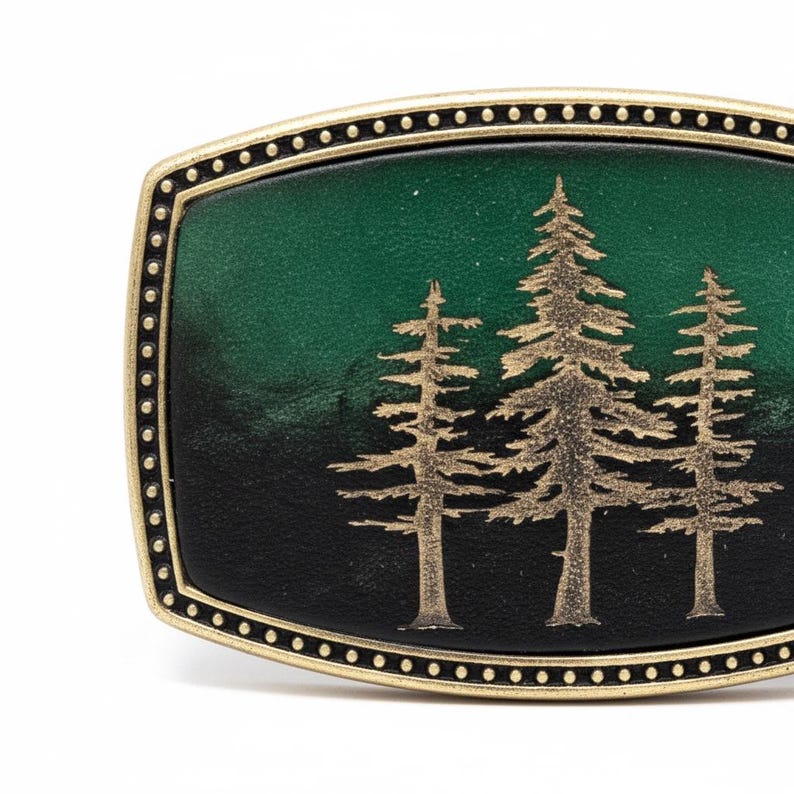 A decorative metal buckle with a green background and gold tree silhouettes.