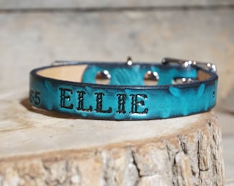 May include: Teal leather dog collar with silver hardware and the name "ELLIE" embossed in black.