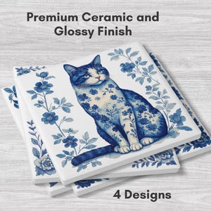 May include: Square ceramic tiles with a glossy finish, featuring a blue and white cat design. The cat is adorned with floral patterns, and the tiles are stacked. The text "Premium Ceramic and Glossy Finish" and "4 Designs" are visible.