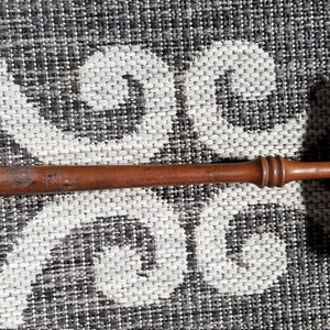 May include: A wooden gavel with a brown handle and a rectangular head. The head is engraved with the text "JAN. 19. 34".
