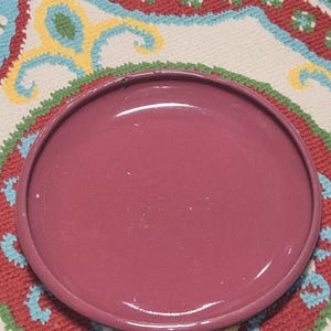 May include: A white ceramic mug with a black handle and the text "But First, Coffee" in a black, bold font. The mug is sitting on a wooden surface. The mug is approximately 4 inches tall.