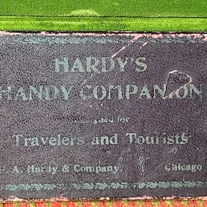 May include: A black and pink book with the title "Hardy's Handy Companion" in white lettering. The book is for travelers and tourists and is published by A. Hardy & Company in Chicago.