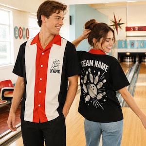 May include: A short-sleeve bowling shirt with a red, white, and black color-blocked design. The front features a chest pocket with a bowling pin graphic and the text NAME. The back displays a large bowling pin graphic and the text TEAM NAME.