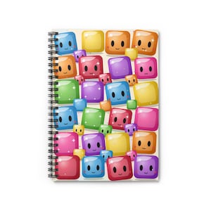 May include: A spiral-bound notebook featuring a colorful pattern of smiling, square-shaped characters in various colors. The design includes blue, green, pink, purple, orange, and yellow blocks with cute facial expressions. The notebook has a white background.