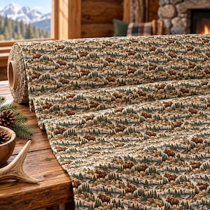 May include: A roll of fabric featuring a repeating pattern of brown moose, green pine trees, and tan mountain landscapes. The textile displays a detailed outdoor scene with earthy tones, showcasing a dense forest and wildlife motif across the surface.