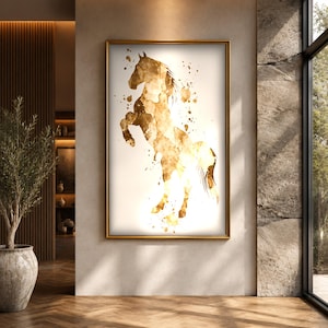 May include: A rectangular wall art print featuring a golden-brown watercolor illustration of a rearing horse. The artwork is encased in a thin gold frame and displays abstract paint splatters and drips surrounding the horse silhouette.