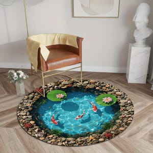 May include: A round area rug featuring a 3D-style print of a koi pond with clear blue water, swimming koi fish, green lily pads with pink flowers, and a border of various smooth river stones, small seashells, and orange starfish accents.