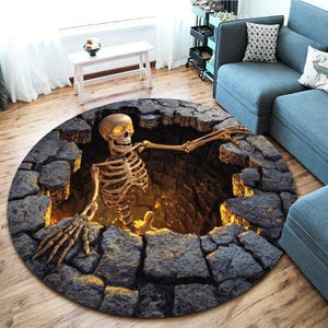 May include: A round area rug featuring a 3D optical illusion of a deep, dark stone well. A beige human skeleton with glowing yellow eyes is emerging from the center of the well, resting its bony hands on the jagged, dark gray stone edges.