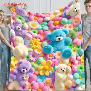 May include: A soft blanket featuring a 2d flat printing of a colorful pattern with multiple teddy bears in shades of blue, purple, and cream, interspersed with various bright flowers and polka-dot spheres in pink, yellow, and green hues.