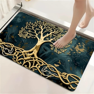 May include: A rectangular floor mat featuring a dark teal and black marbled background with a prominent gold-colored tree design. The tree has intricate, sprawling roots that extend across the bottom portion of the mat in a knotted pattern.