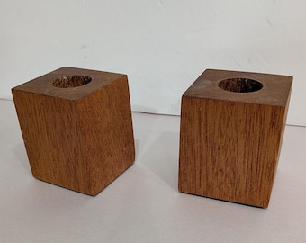 Set van 2 massief houten kubusvormige kaarsenstandaards in mid-century modern stijl met vilten onderkant.