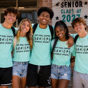 May include: Five individuals wearing matching light teal t-shirts with black text that reads: OUR FINAL CHAPTER SENIORS SEASON 20 EPISODE 27. The shirts feature colorful dots between the letters of the word SENIORS, mimicking a television show logo.