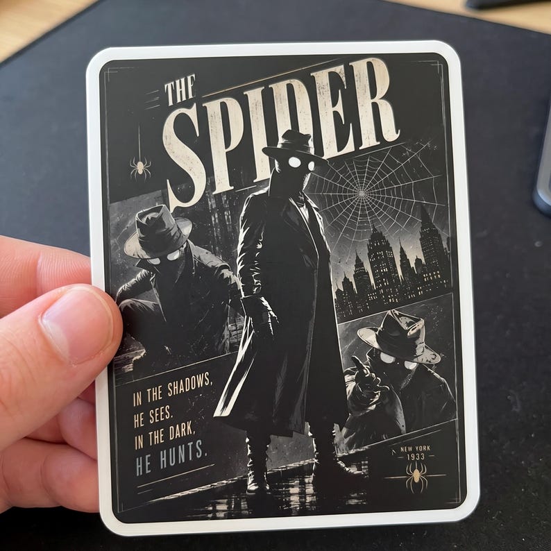 May include: A black and white sticker featuring a vintage comic book style illustration of "The Spider." The image shows a figure in a trench coat and fedora, with the text "In the shadows, he sees. In the dark, he hunts."