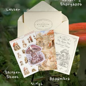 May include: A stationery set including a cream envelope with a Rachaelish Story logo, a sticker sheet with mushroom and animal illustrations, a die-cut vinyl sticker of a rabbit under a mushroom, a bookmark, and a colouring storybook titled The Rainy Day Mushroom Village.