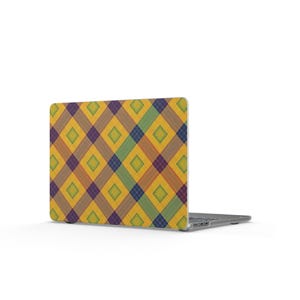 May include: A laptop computer featuring a protective skin on its lid with a repeating diamond pattern in shades of yellow, green, blue, and brown. The geometric design consists of intersecting diagonal lines forming a grid of squares and diamonds.