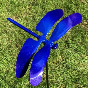 A blue Metal Dragonfly Sculpture Lawn Stake