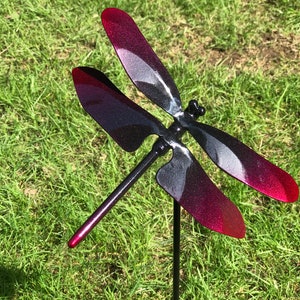 A black & red Metal Dragonfly Sculpture Lawn Stake