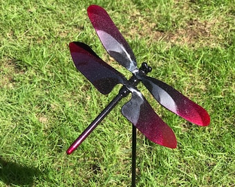 A black & red Metal Dragonfly Sculpture Lawn Stake