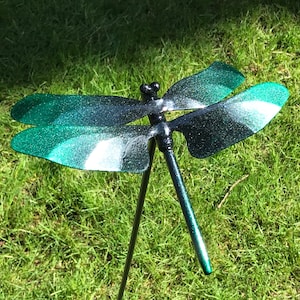 A black & green Metal Dragonfly Sculpture Lawn Stake