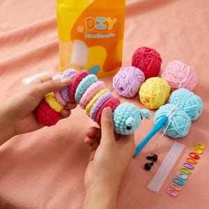 Può includere: Un kit per uncinetto DIY Handicrafts con un bruco di peluche multicolore composto da segmenti di filato interconnessi, diversi gomitoli di filato morbido rosa, giallo, blu e viola, un uncinetto blu, due occhi di sicurezza neri e segnapunti.