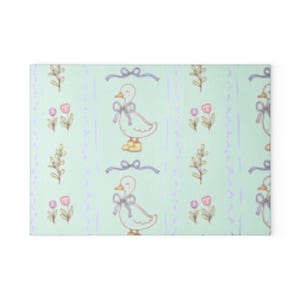 May include: A light mint green fabric featuring a repeating pattern of a white duck wearing a blue bow and yellow boots, accented by blue ribbons, small pink tulips, and thin vertical purple lines arranged in a structured, repeating layout.