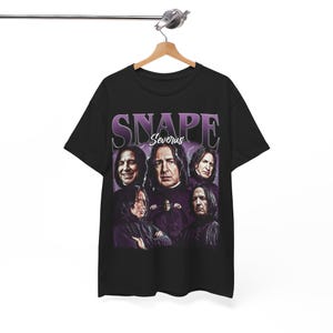 May include: A black short-sleeve t-shirt featuring a graphic print of Severus Snape in various poses. The design includes the text "SNAPE" in large purple letters at the top and "Severus" in white script below, set against a purple lightning background.