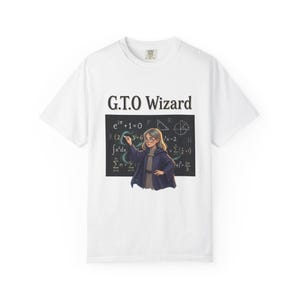 May include: A white short-sleeve t-shirt featuring the text G.T.O Wizard above a graphic of a person in a dark blue robe writing mathematical equations on a black chalkboard. The design includes various symbols like integrals and summations.