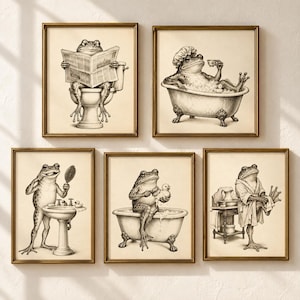 May include: A set of five framed wall art prints featuring black and white illustrations of frogs in a bathroom. The frogs are depicted performing various daily routines including reading on a toilet, bathing in a tub, brushing teeth, and drying off.