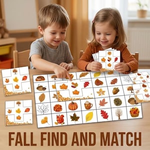 May include: A fall-themed matching game featuring a large rectangular board and several smaller square cards. The game pieces display illustrations of autumn leaves, acorns, pumpkins, a squirrel, and trees in shades of orange, brown, and yellow.