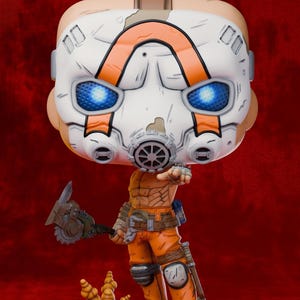 May include: A Borderlands Psycho figurine featuring a large white mask with orange markings and glowing blue eyes. The character wears orange pants, holds a buzz axe, and stands on a base labeled BORDERLANDS. Text includes CACTUS 3D ATELIER.