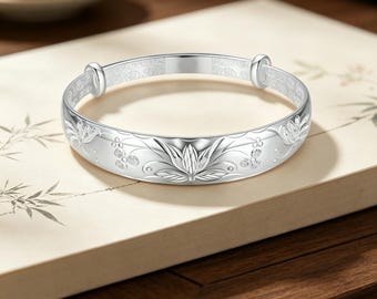 Vintage Chinese lotus relief 999 sterling silver bracelet, hand-carved floral adjustable push-pull design.