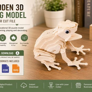 May include: A 3D wooden frog model puzzle featuring laser-cut light wood pieces, a single dark eye, and a wide mouth. The image includes text: WOODEN 3D FROG MODEL, DIY LASER CUT FILE, DIGITAL DOWNLOAD, 3 FILE FORMATS INCLUDED, DXF, CDR, and SVG.