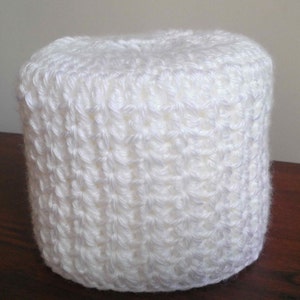 May include: White crocheted toilet paper roll cover.