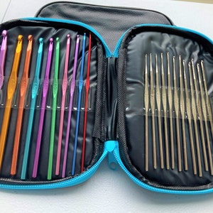 May include: A black zippered case with a blue trim holds a set of 20 knitting needles. The needles are arranged in two rows, with the smaller needles on the top row and the larger needles on the bottom row. The needles are all silver in color and have a smooth finish.