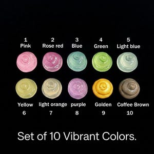 May include: A set of 10 small, round, swirled objects in various colors labeled 1 through 10: Pink, Rose red, Blue, Green, Light blue, Yellow, light orange, purple, Golden, and Coffee Brown. The text at the bottom reads Set of 10 Vibrant Colors.