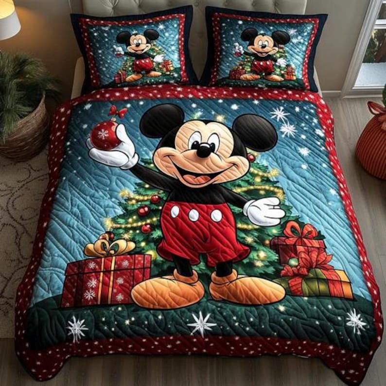 May include: A Christmas-themed bedding set featuring Mickey Mouse. The quilt and pillowcases display Mickey in front of a Christmas tree, surrounded by gifts and snowflakes. The color palette includes red, blue, green, and white.