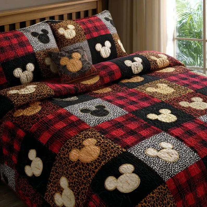 May include: A patchwork quilt and pillow set featuring a red and black plaid pattern, leopard print, and black and white spots. Mickey Mouse silhouettes are appliqued on the squares. The bedding set includes a quilt and two pillow shams.