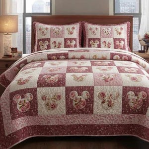 May include: A patchwork quilt and two pillow shams featuring a floral Mickey Mouse design. The quilt and shams have a red, pink, and white color scheme. The quilt is made of squares with Mickey Mouse heads and floral patterns.