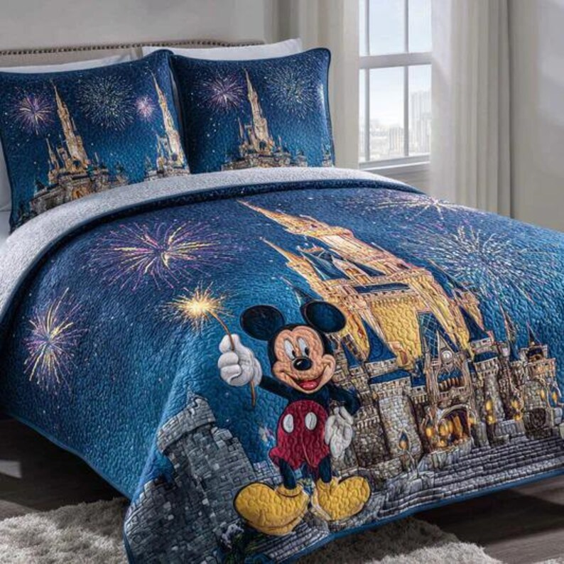 May include: A blue quilted bedspread and two pillowcases featuring a castle, fireworks, and Mickey Mouse. The bedding has a dark blue background with a gold castle and colourful fireworks. Mickey Mouse is holding a sparkler.