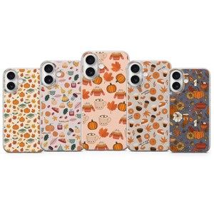 May include: Five clear smartphone cases featuring various autumn-themed patterns. Designs include orange pumpkins, colourful fall leaves, cosy sweaters, warm mugs of coffee, slices of pie, and books, arranged in repeating motifs on a transparent background.