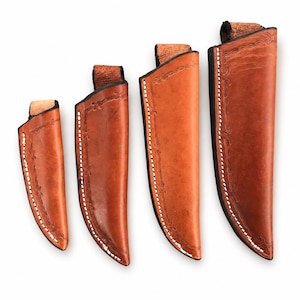 May include: Four tan leather knife sheaths arranged in ascending order of size. Each sheath features a smooth, polished surface, white stitched edges, and a decorative embossed border pattern along the side, with a small loop at the top.