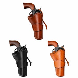 May include: Three revolvers with wooden grips, each housed in a leather holster. One holster is dark brown, one is black, and one is light tan. Each holster features a stitched edge, a wide strap across the front, and a leather cord tie.