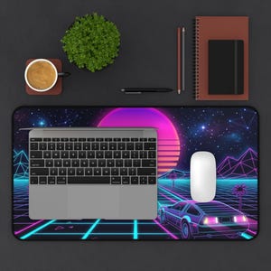 Può includere: Tappetino per scrivania per computer con un design retrò anni '80 con un'auto DeLorean, palme e un tramonto vibrante. Un laptop, un mouse, una tazza di caffè, una pianta e articoli di cancelleria sono su una superficie scura.