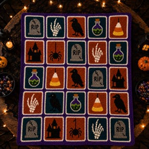 May include: A rectangular crochet blanket featuring a grid of twenty-five squares with Halloween-themed motifs including gray tombstones with RIP text, white skeleton hands, black ravens, purple potion bottles, candy corn, and black haunted houses.