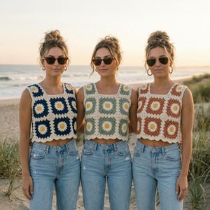 May include: Three sleeveless crochet crop tops featuring a square granny motif with a central yellow flower and white petals. The tops are rendered in navy blue, sage green, and terracotta, each paired with light blue denim jeans and sunglasses.