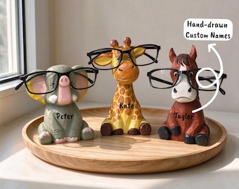 May include: Three carved animal eyeglass holders shaped like an elephant, a giraffe, and a horse. Each figure wears black glasses and features a name: Peter, Kate, and Taylor. A white graphic includes the text Hand-drawn Custom Names.