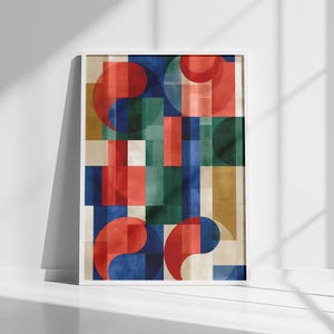 May include: A rectangular wall art print featuring a geometric composition of overlapping circles and vertical rectangles in shades of red, deep blue, forest green, and muted gold, all enclosed within a simple white frame.