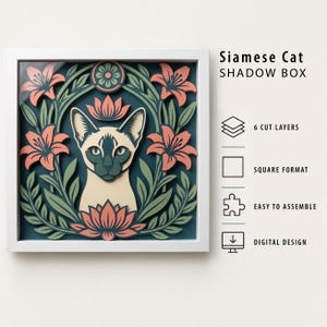 May include: A square shadow box featuring a layered Siamese cat illustration surrounded by pink lilies and green foliage on a dark blue background. Text reads: Siamese Cat SHADOW BOX, 6 CUT LAYERS, SQUARE FORMAT, EASY TO ASSEMBLE, DIGITAL DESIGN.