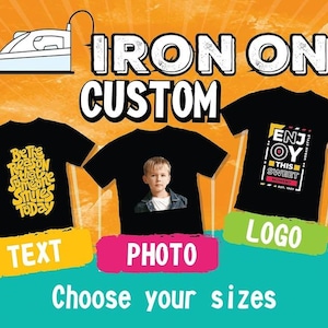 May include: Three black t-shirts displayed against an orange background. The left shirt features yellow text reading Be the reason that someone smiles today. The centre shirt displays a photo of a child. The right shirt shows a logo with the text ENJOY THIS SWEET MOMENT. An iron icon is at the top.