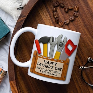 May include: White ceramic mug with a handle, featuring a Father's Day design. The design includes cartoon tools like a hammer, wrench, and saw, along with the text "Happy Father's Day." The names Sophia, David, Jenny, Lucas, and Jack are also included.